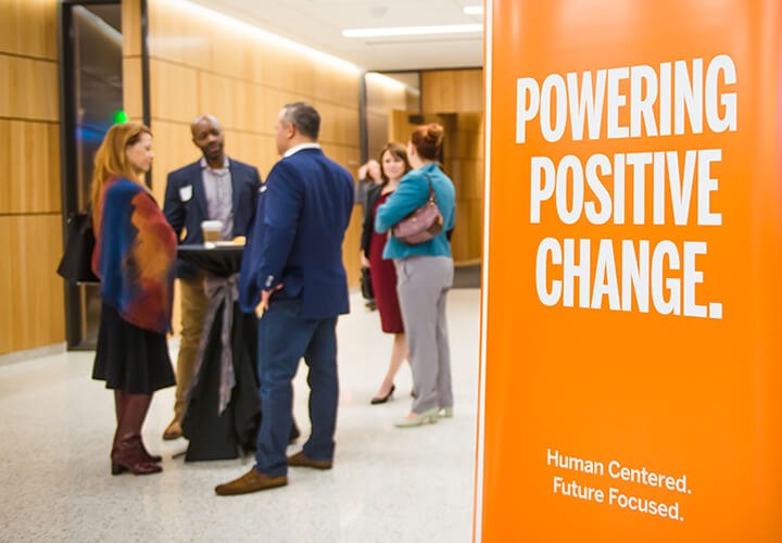 Powering Positive Change sign at alumni event