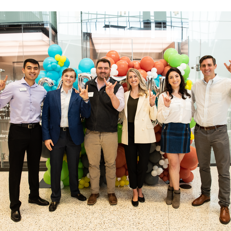 Students in front of balloons at 2022 MBA Capstone Showcase
