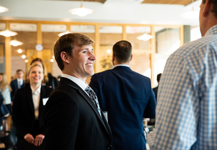 Event attendee smiles in business casual attire