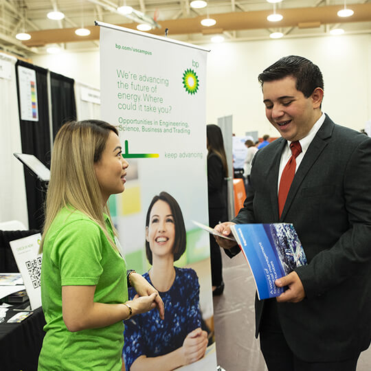 Conference attendee speaks at BP vendor booth