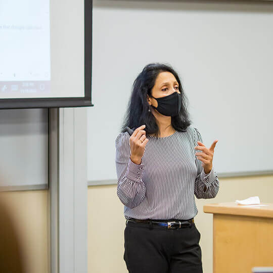 Masked instructor gestures while speaking