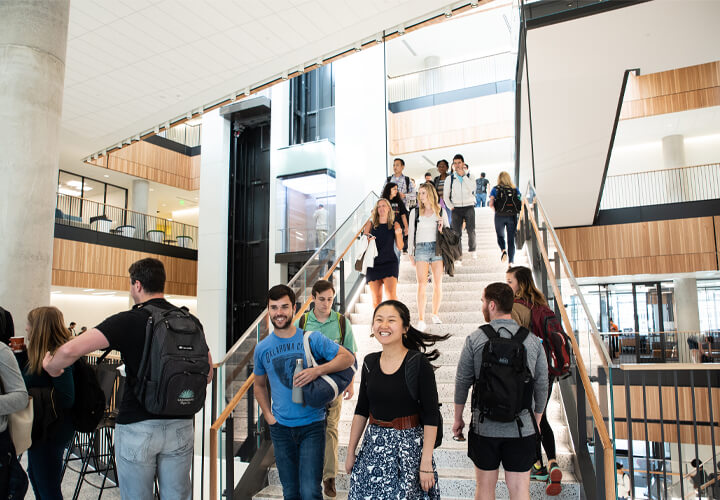 Students walking down stairs in Rowling Hall