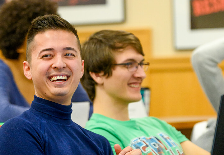 Two MS Program students laugh in class