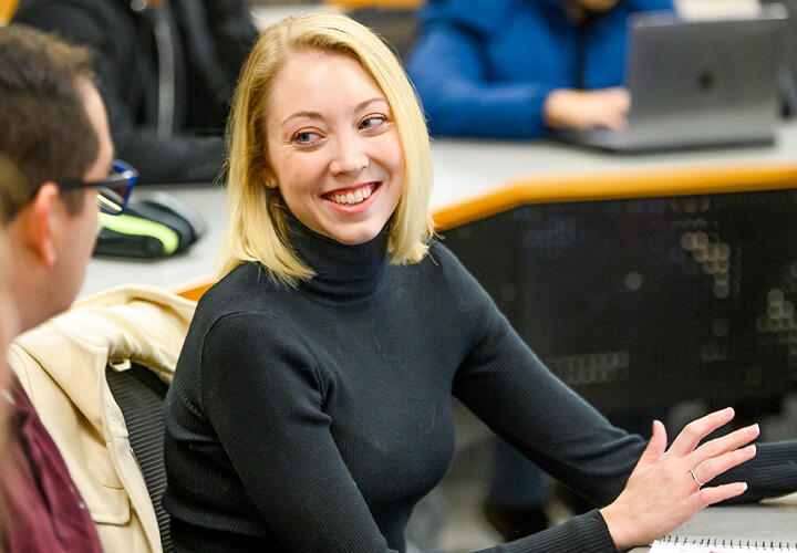 MS Program student smiles in class