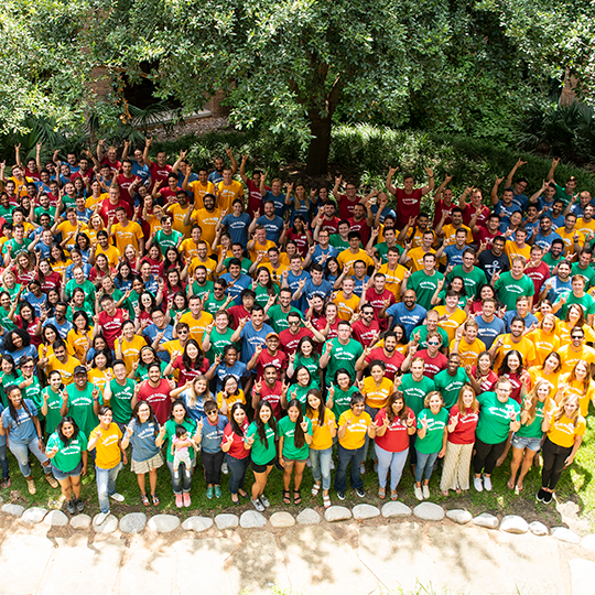 group of MBA students in various colored t-shirts