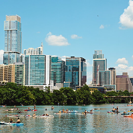 Kayakers on Lady Bird Lake with Austin skyline in background