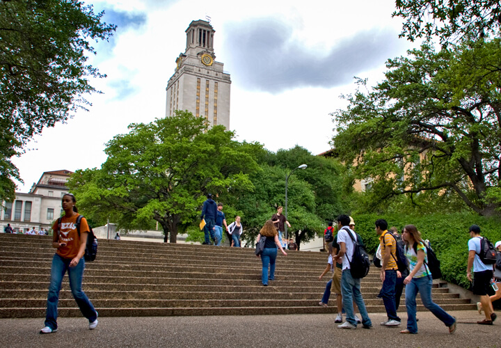 Students walking on stairs in front of University of Texas tower