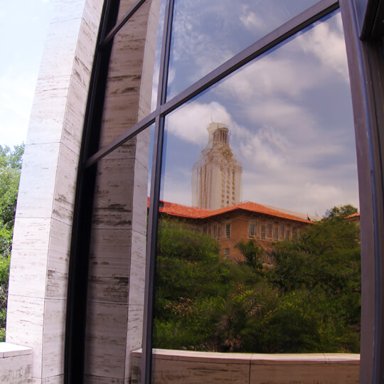 Reflection of University of Texas tower in a building window