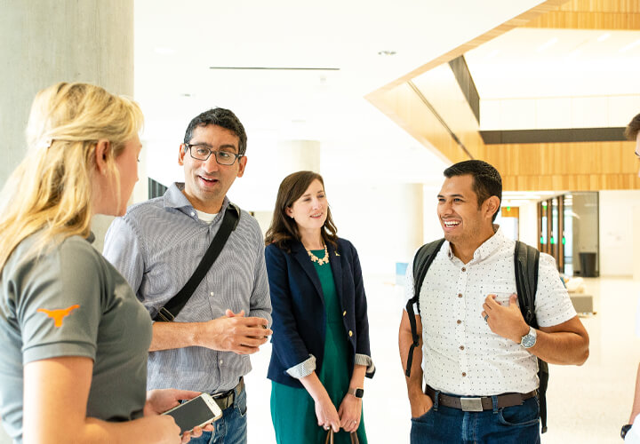 Four startup week attendees talk in Rowling Hall lobby