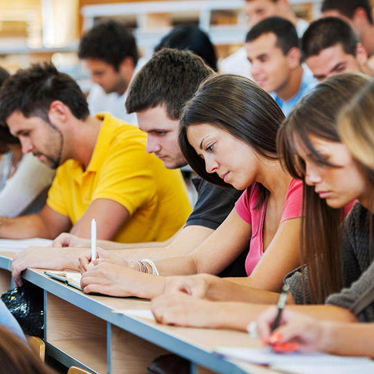 Group of students take notes in class