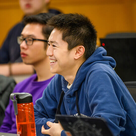 MS Program student smiles in class
