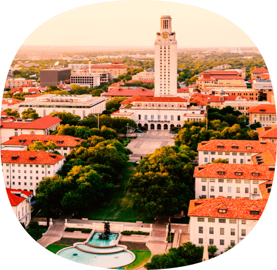 Aerial view of the University of Texas tower and buildings with orange roofs.