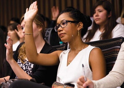 Student raising her hand in class