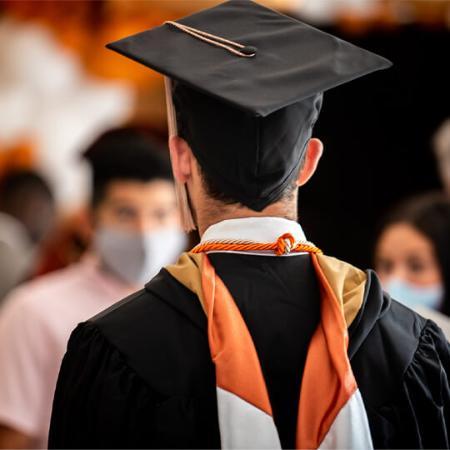Dean Mills handing a diploma to an Master's in Professional Accounting (MPA) program graduate
