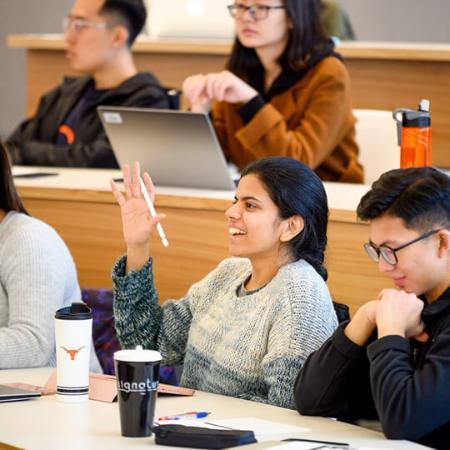 Student raising her hand in class