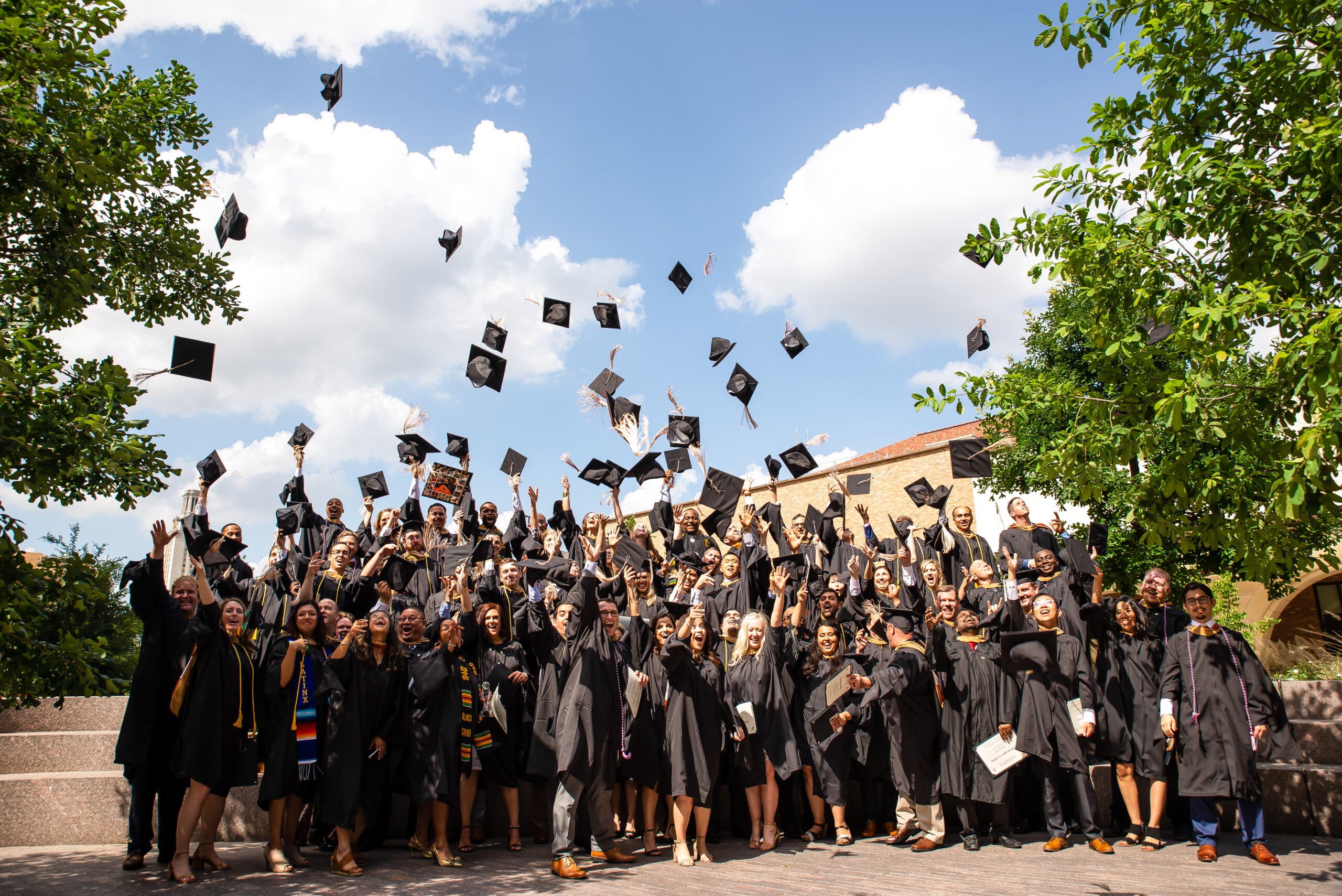 Group of students looking at a laptop