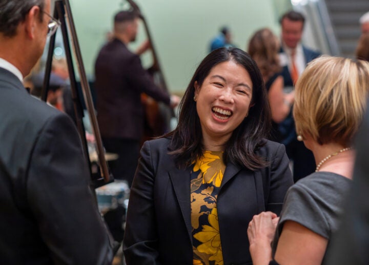 Woman laughing in conversation at an event