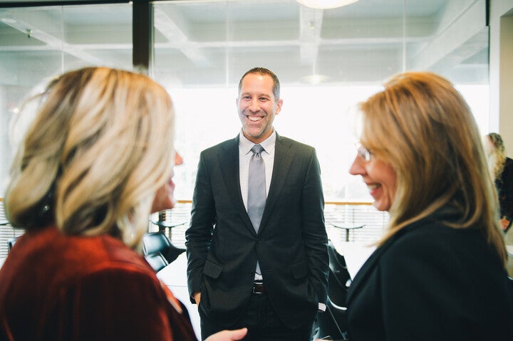 Three people having a discussion and smiling
