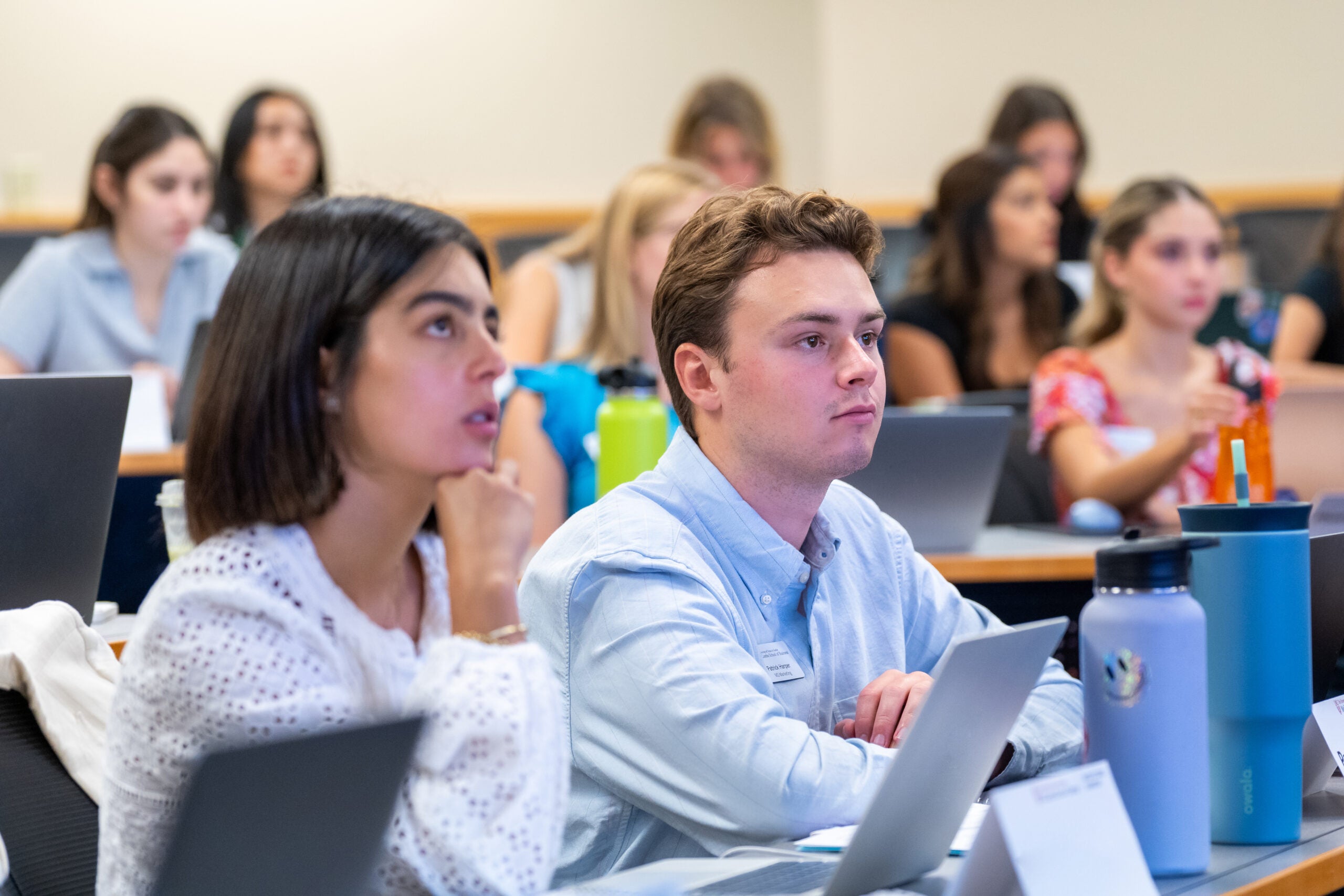 People in business attire talking at an event