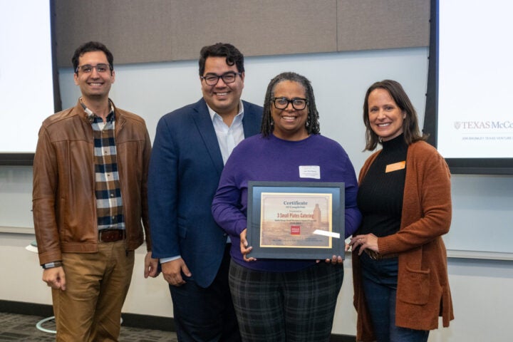 Group of people smiling after winning an award
