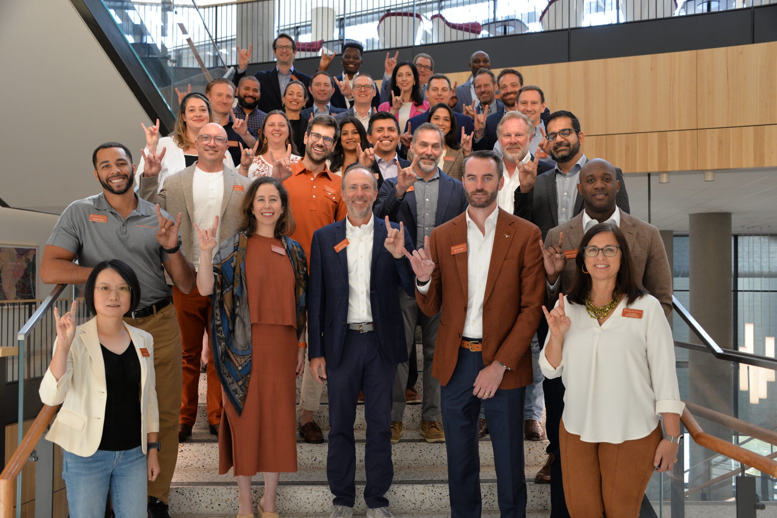 Group photo of MBA Advisory Board members standing on stairs in Rowling Hall