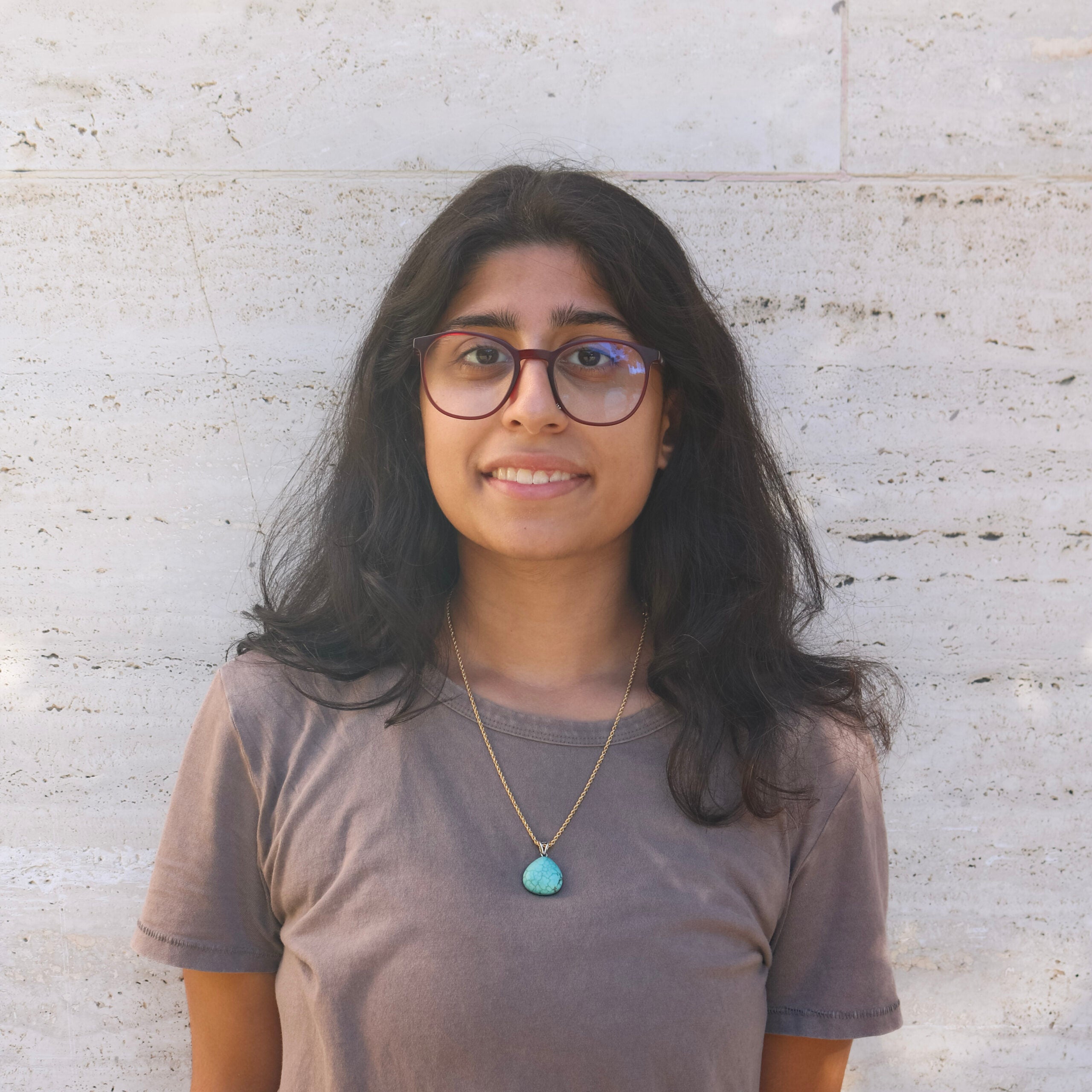 MPA student posing in front of a wall.