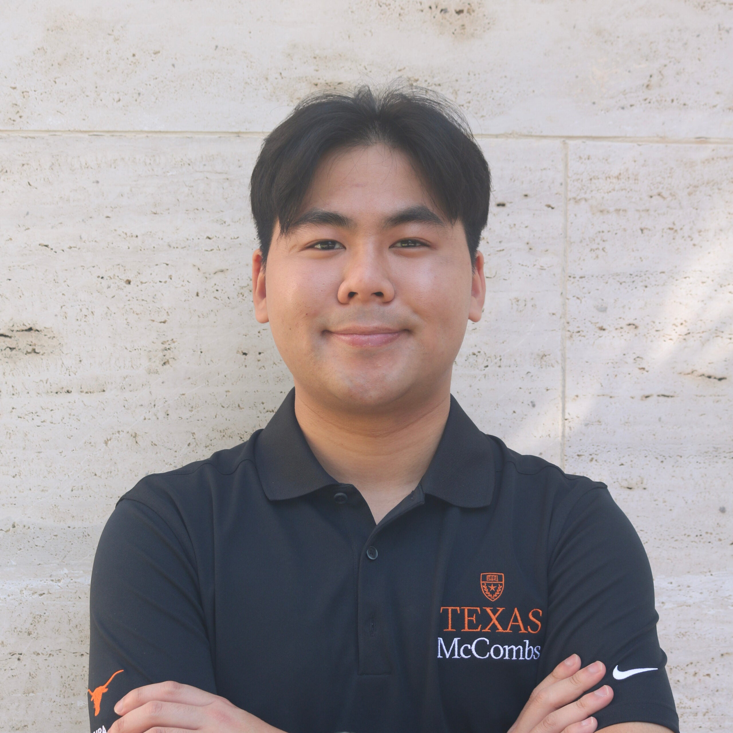 MPA student posing in front of a wall.