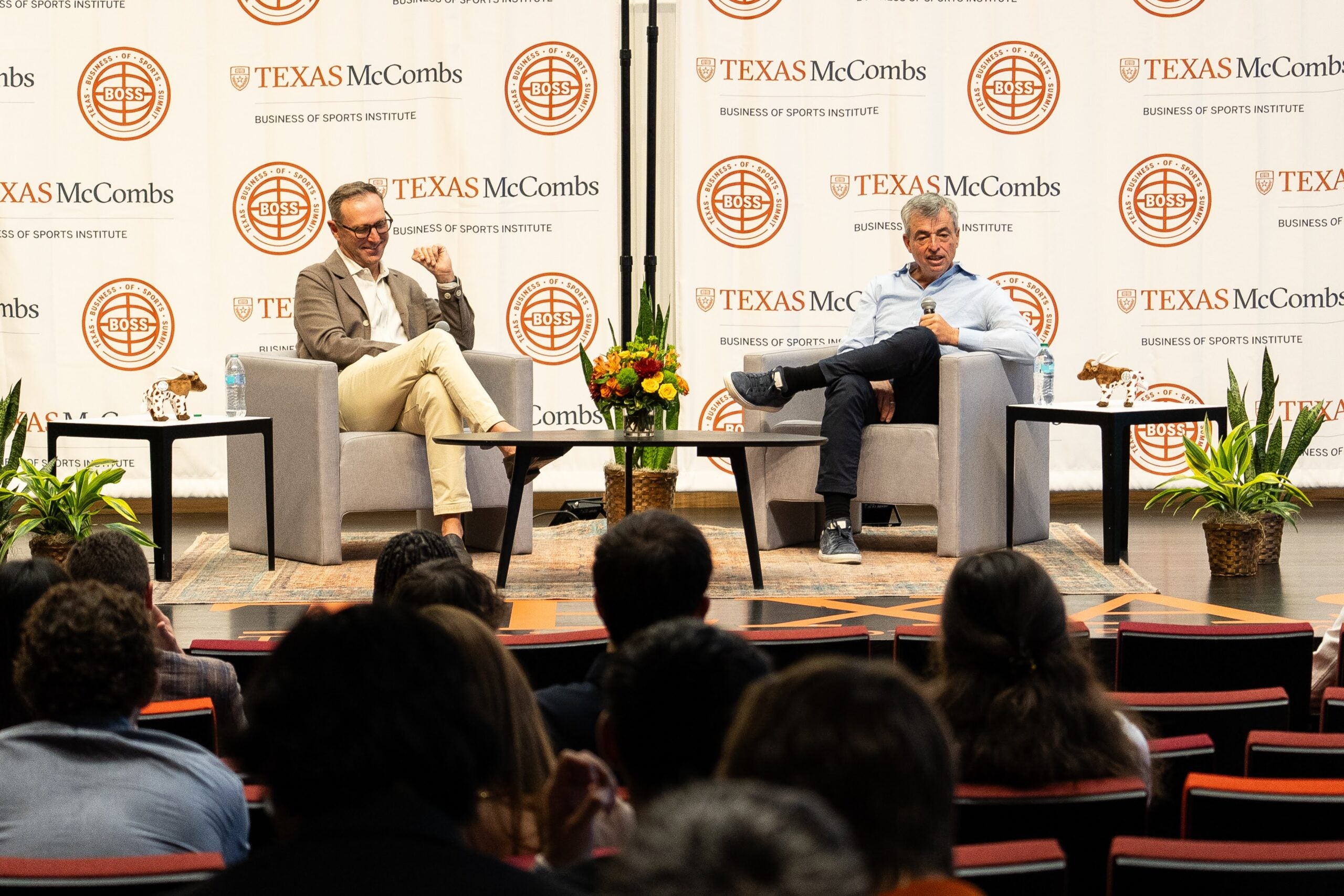 UT football players take the field holding an American flag