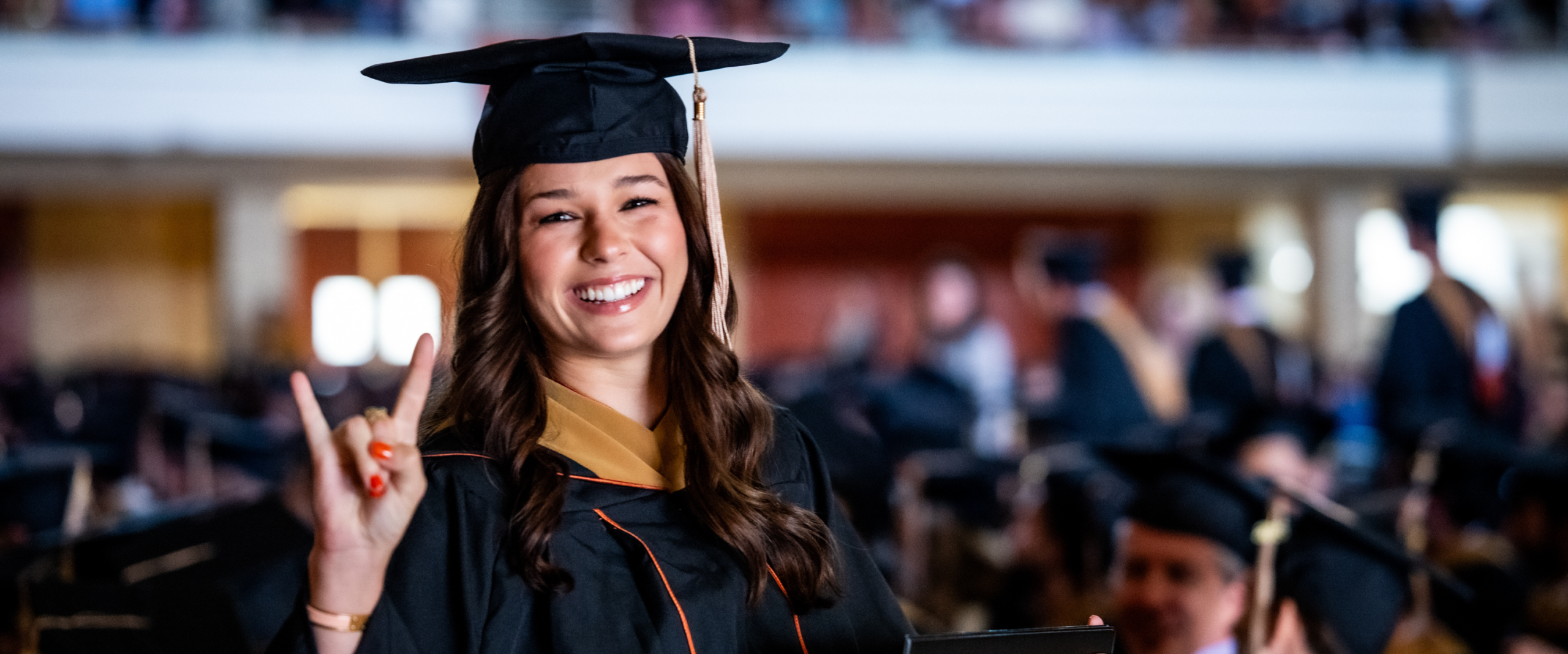 McCombs specialized master's program student in graduation regalia
