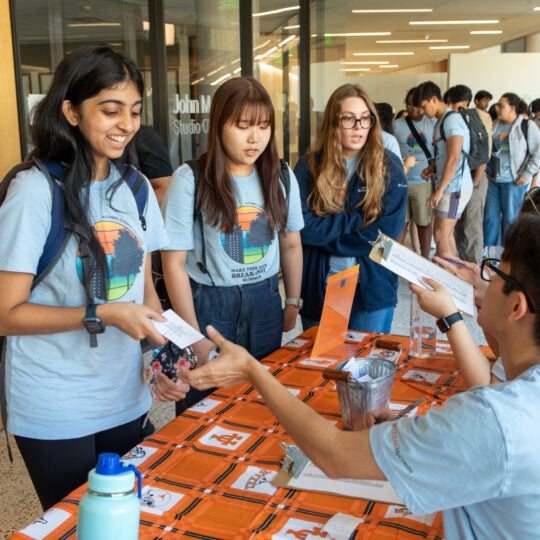 Students getting information at an event