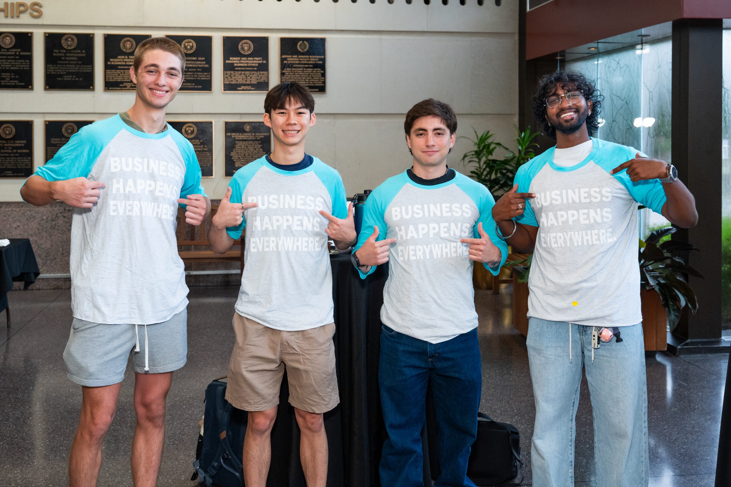 students posing in McCombs Summer Institute tshirts