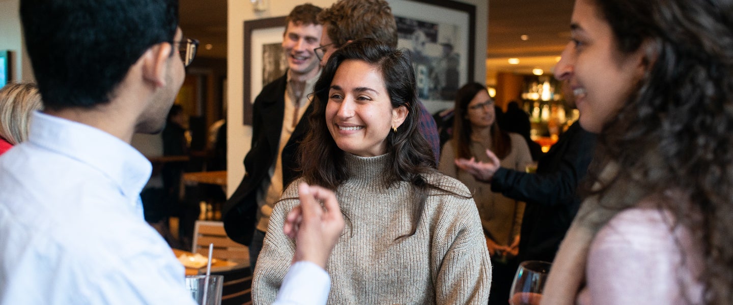 Graduate students interacting at an event