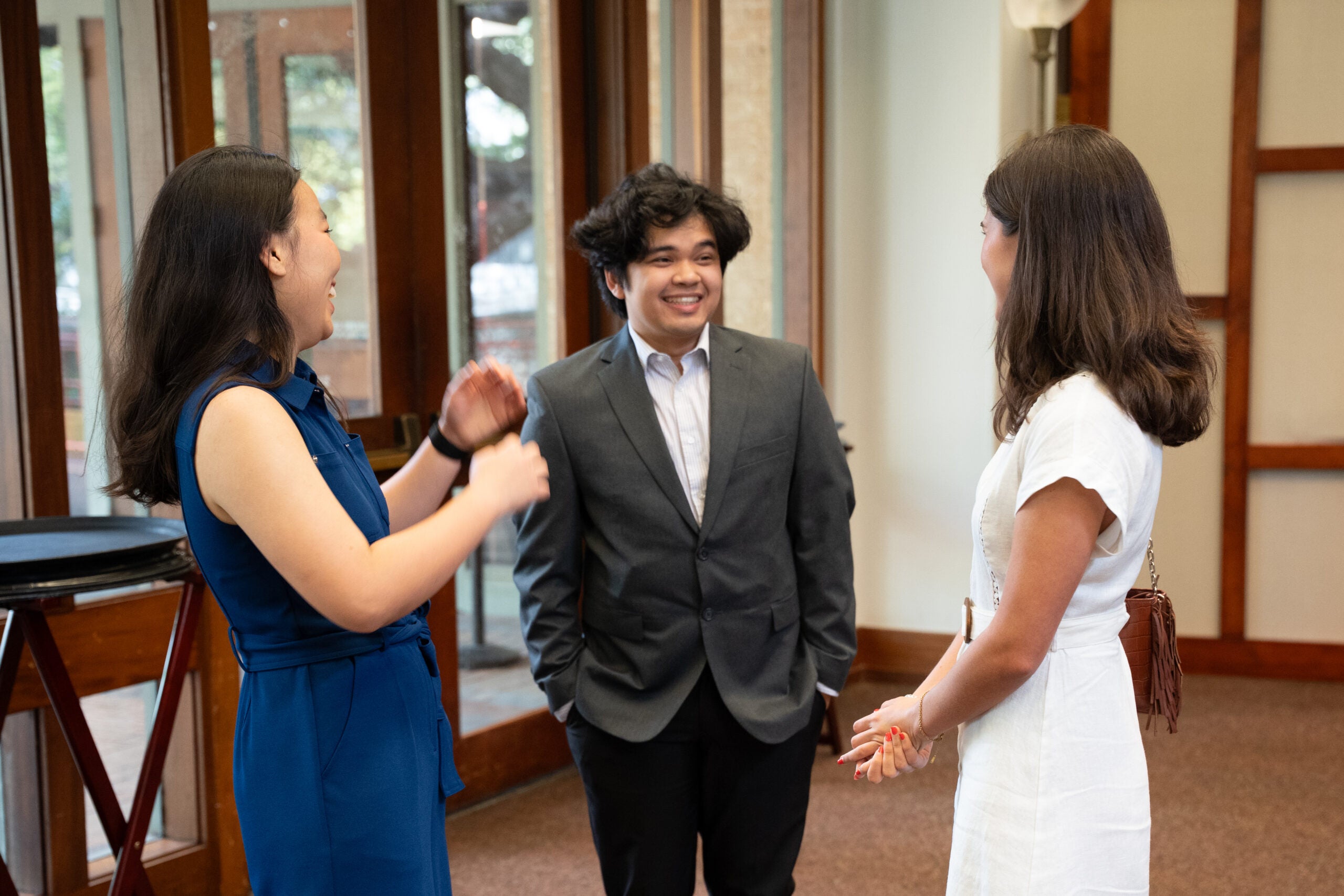 Three people in business attire talking